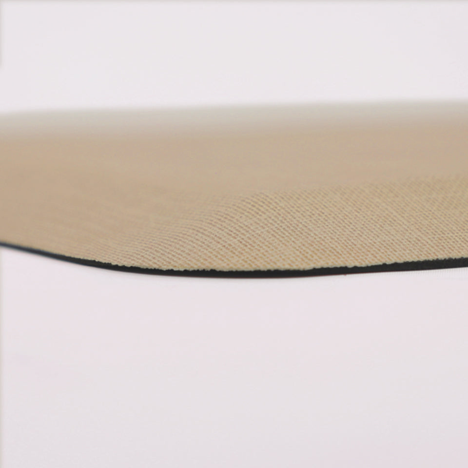 Detailed corner image of the anti-fatigue Happy Feet's Linen mat in a soft sand shade. The low profile shot highlights the 5/8" thick mat and the beveled edging on a white background.