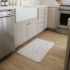 Happy Feet anti-fatigue mat in a kitchen in front of a sink for stand comfort and a waterproof surface for spills and messes