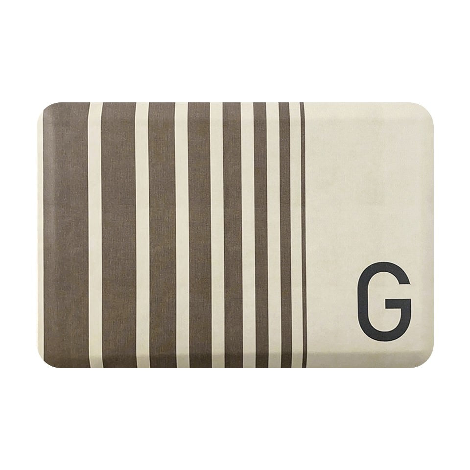 Anti-fatigue mat with classic design of brown stripes on a cream background with a monogrammed letter.