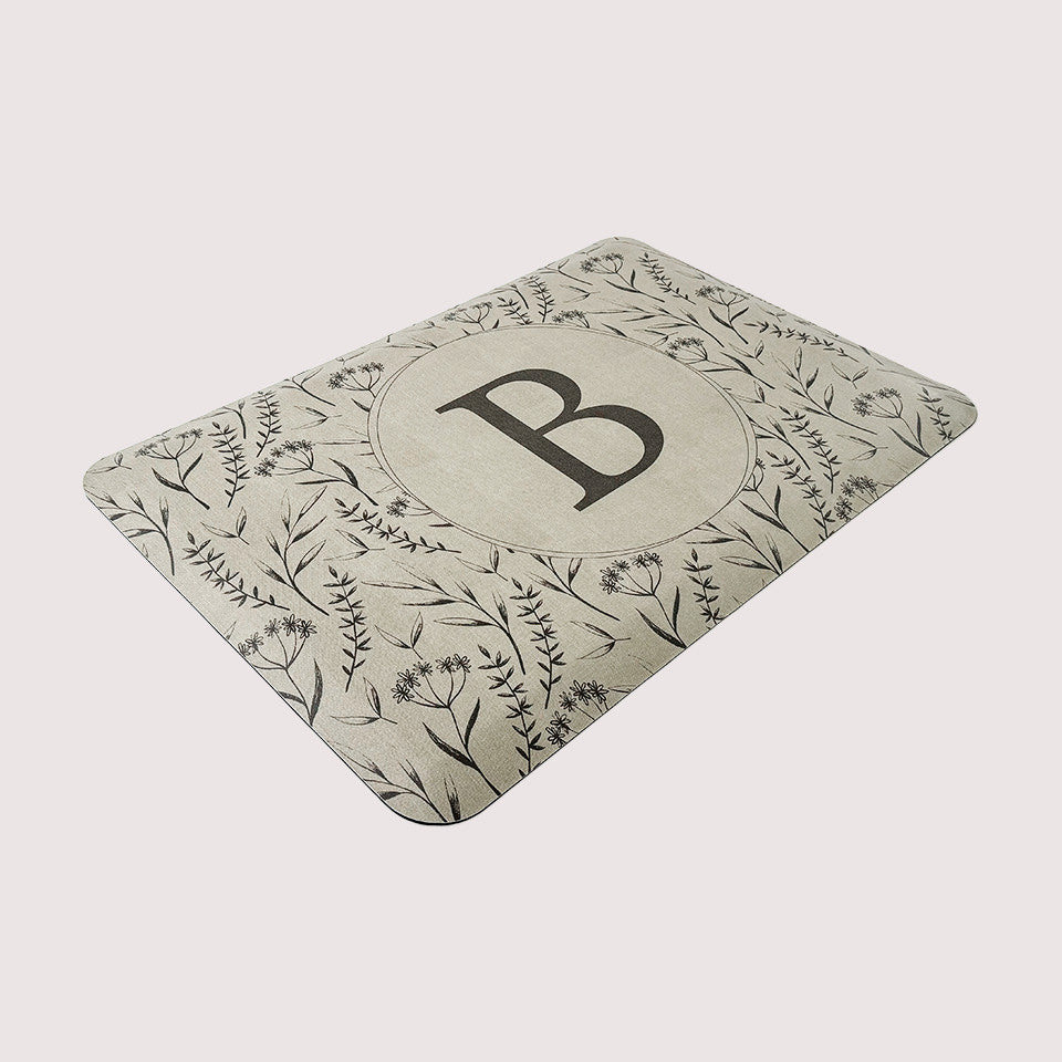 Happy Feet’s Monogrammed Botanical anti-fatigue small mat made with comfortable foam and a wipeable surface for an easy clean.
