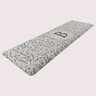 Happy Feet’s Monogrammed Botanical anti-fatigue runner mat with comfortable foam and a wipeable surface for an easy clean.