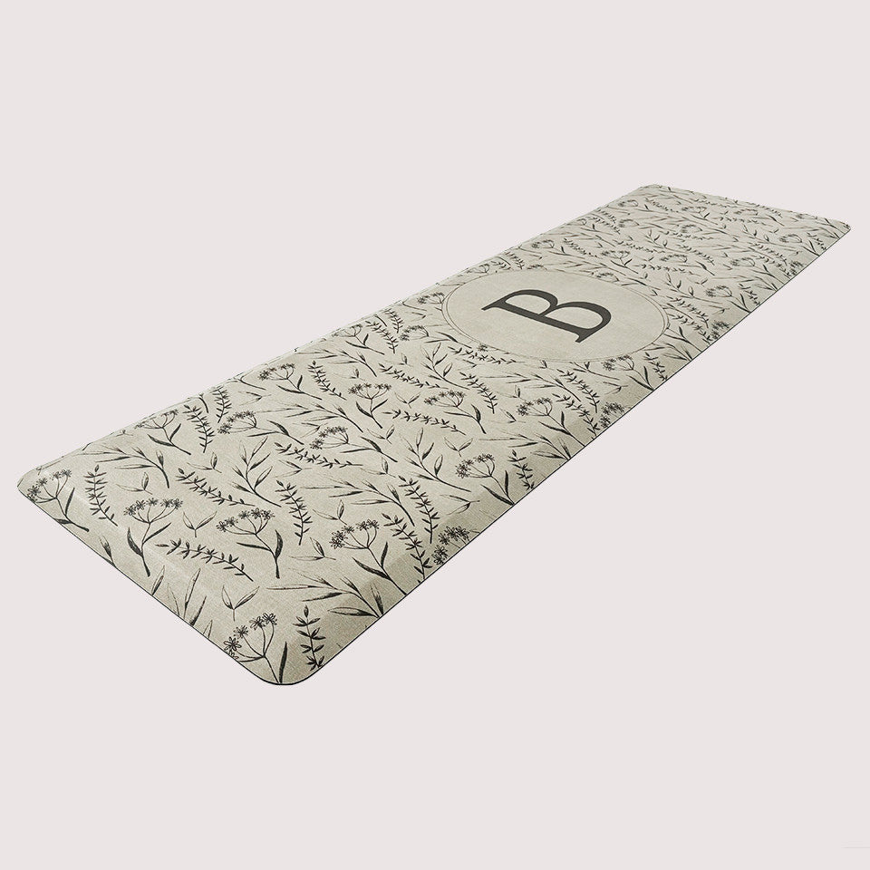 Happy Feet’s Monogrammed Botanical anti-fatigue runner mat with comfortable foam and a wipeable surface for an easy clean.