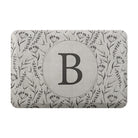 Personalized mat for standing comfort with a beautiful, thin floral design and monogrammed circle in the center.