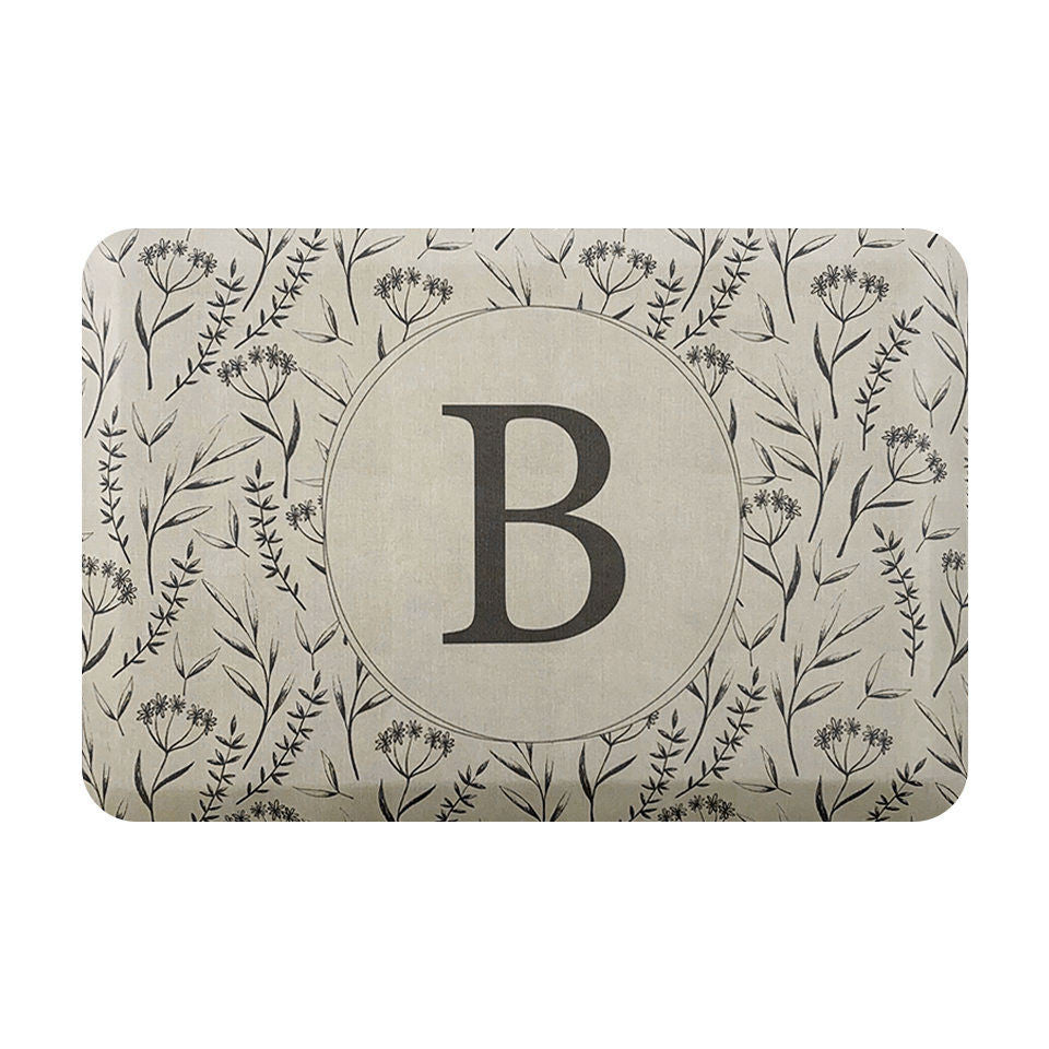 Personalized mat for standing comfort with a beautiful, thin floral design and monogrammed circle in the center.