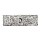 Personalized runner mat for standing comfort with a beautiful, thin floral design and monogrammed circle in the center.