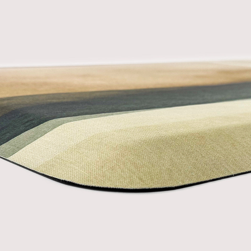 Corner image of beautiful anti-fatigue mat with foam comfort. Surface is abstract watercolors in a canvas-like texture.