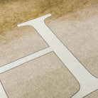 closeup of Happy Feet Monogrammed mat. White letter monogrammed on a watercolor design with canvas-like texture.