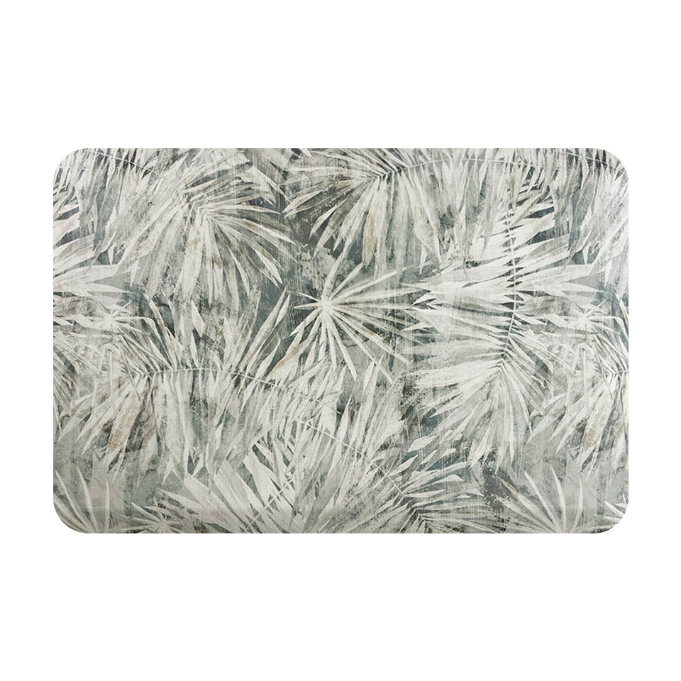 Happy Feet’s Tranquil Palms anti-fatigue small mat with overlapping palm leaves in a transparent manner.