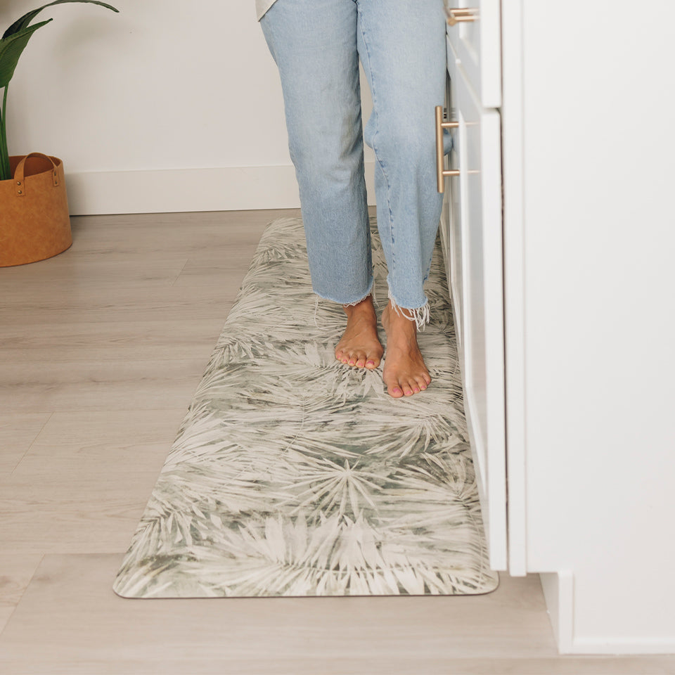 Incredibly comfortable Tranquil Palms Happy Feet kitchen comfort mat with bare feet standing on the runner.