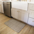 Variegated Vine anti-fatigue mat in grey with a white pattern on a light oak kitchen floor 