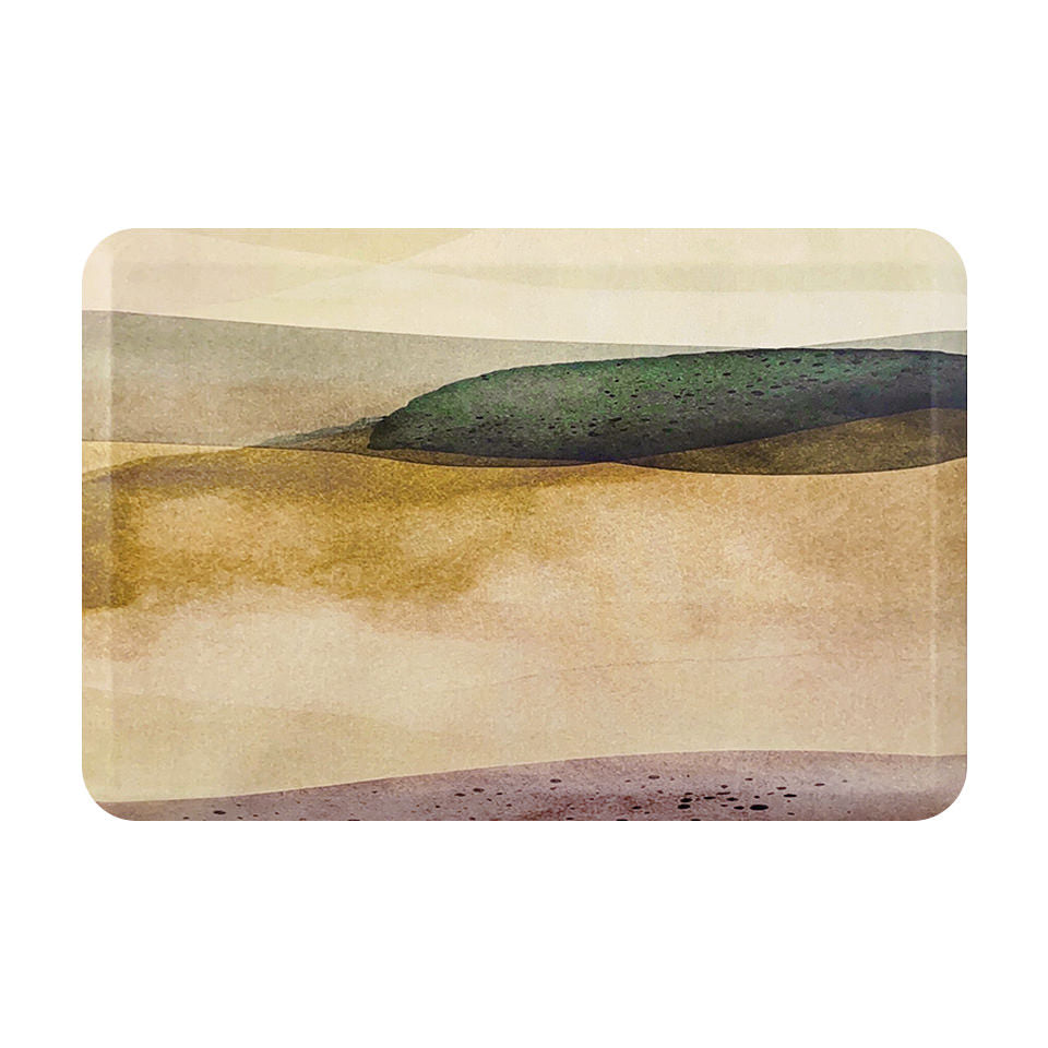Overhead image of beautiful anti-fatigue indoor mat with watercolor style landscape scenery in muted tones of beige, sand, green, and pink