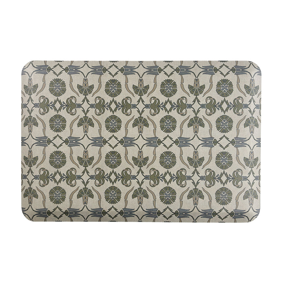 Happy Feet’s Zahra Leaf anti-fatigue small mat features an alternating leaf motif in earth tones on a beige background.