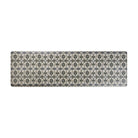 Happy Feet’s Zahra Leaf anti-fatigue runner mat features an alternating leaf motif in earth tones on a beige background.