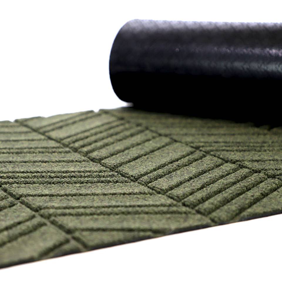 Close up of rubber backing on our bi level non shedding doormat in olive green chevron pattern