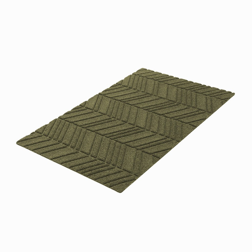 Olive green chevron doormat on isolated background