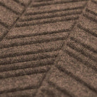 Close up of greige colored doormat with chevron styled pattern