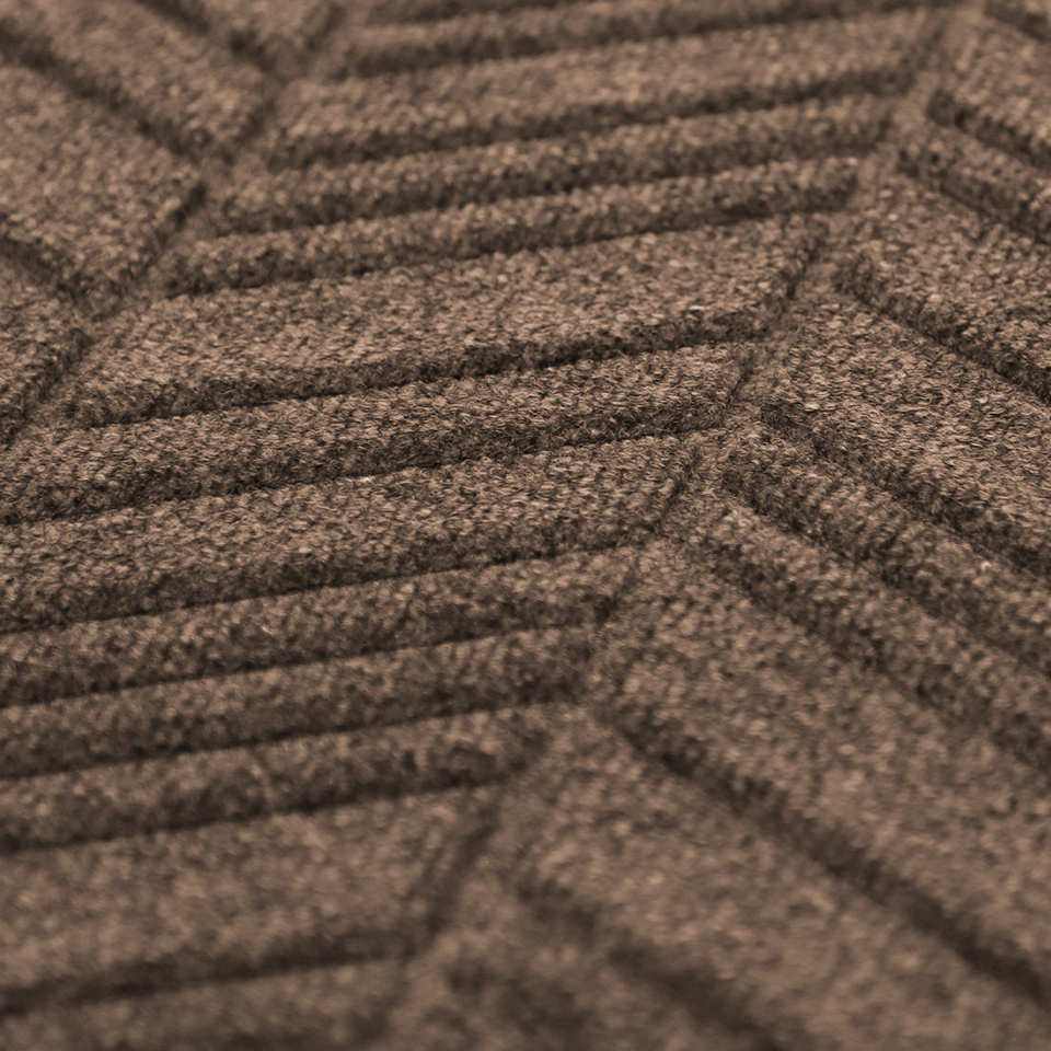 Close up of greige colored doormat with chevron styled pattern