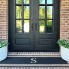 A double door initial stripes monogrammed doormat out side french doors with the letter S.