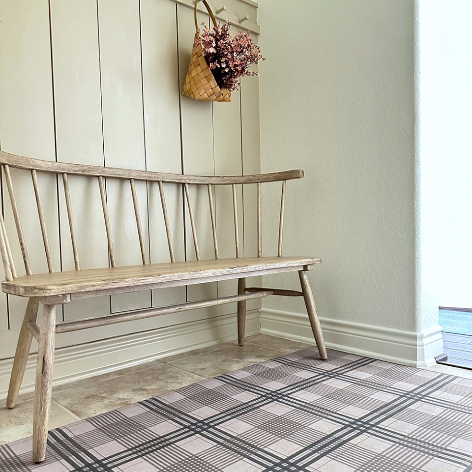 Un-Rug placed in entryway shown in shiitake tan printed linen texture with urbane bronze brown plaid stripes on a low profile washable indoor floor mat.