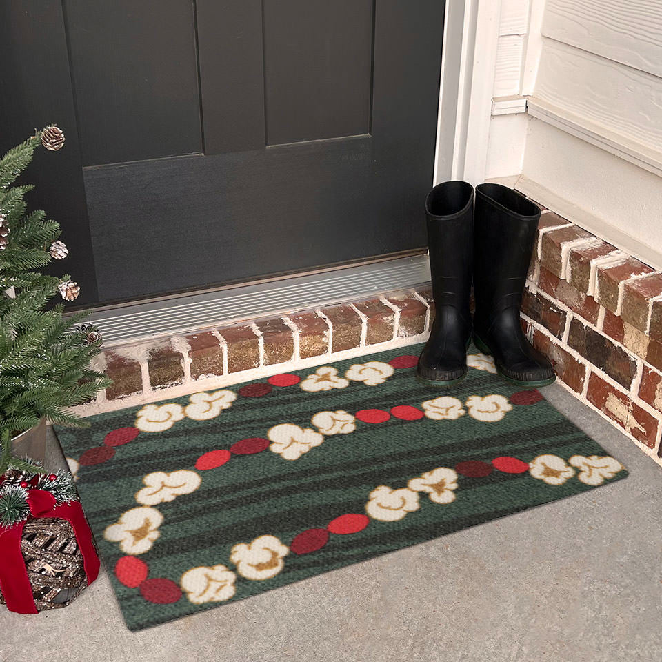 Classic holiday themed doormat featuring a classic garland design with pops of red and white on a dual green background looks great on a Christmas decorated front porch.
