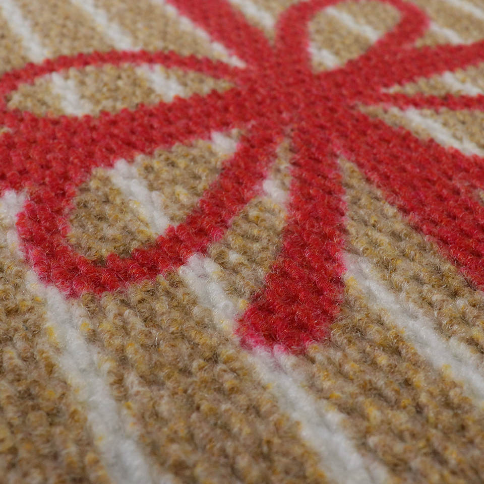 Unique textured holiday doormat with red bow.