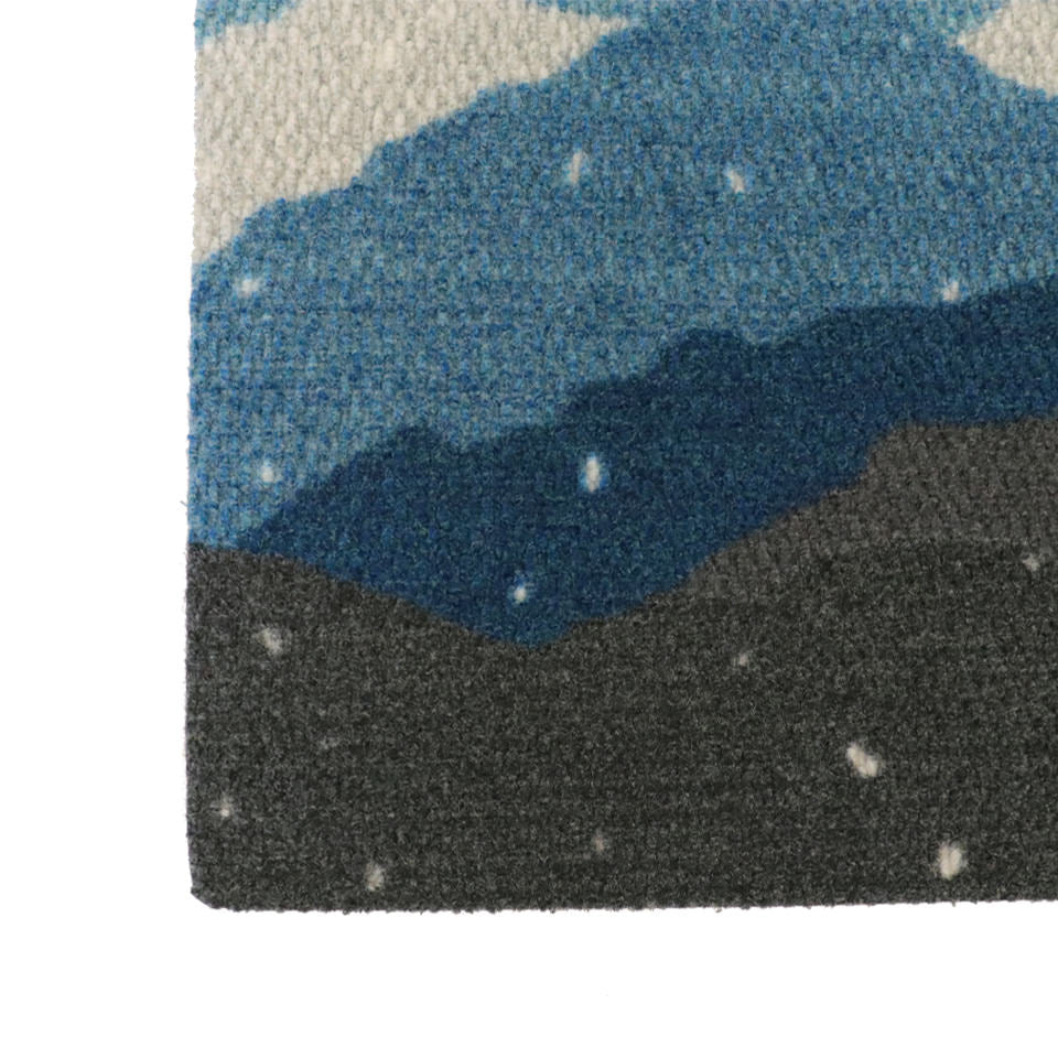 Beautiful wintery landscape doormat; featuring snowy mountains in shades of blues, greens, and white with rounded corners.