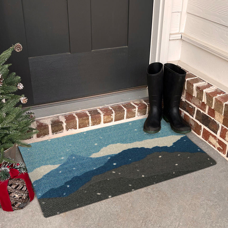 Holiday decorated front porch with beautiful wintery landscape welcome mat; featuring snowy mountains in shades of blues, greens, and white.