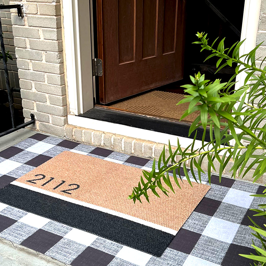 A beautiful Modern Main personalized doormat in shades of black and light brown, with custom text showcasing a house and apartment number on the doormat surface.