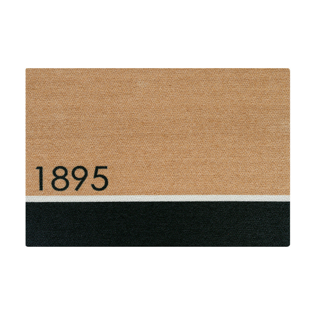 A large tan and black colored doormat divided by a white line in the lower thirds personalized with street numbers '1895' in black text