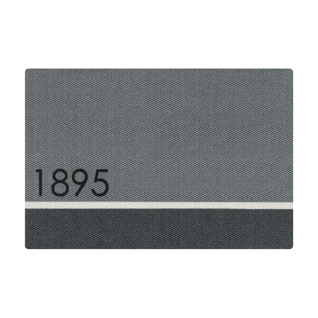 A large light and dark grey colored doormat divided by a white line in the lower thirds personalized with street numbers '1895' in black text