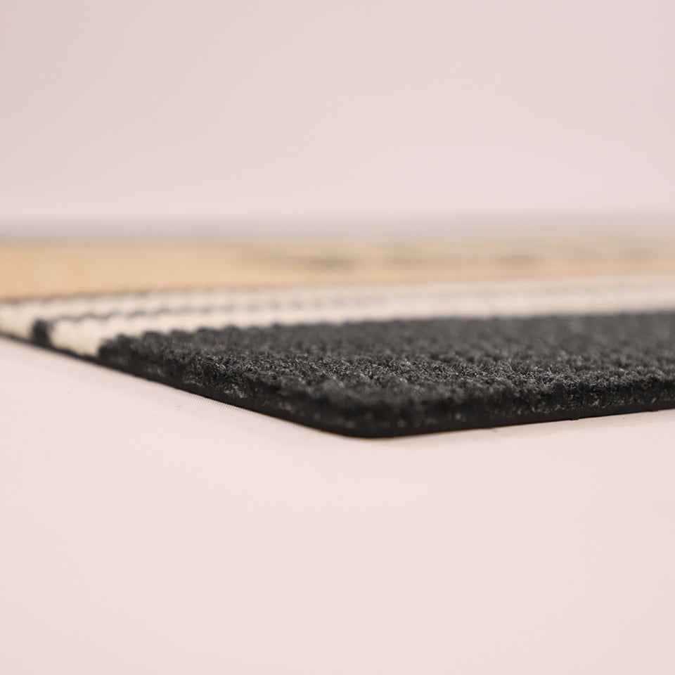 Close-up corner shot of Modern Moniker’s low profile and nonshedding black, white, and coir surface.