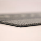 Close-up corner shot of Modern Moniker’s low profile and nonshedding grey surface.