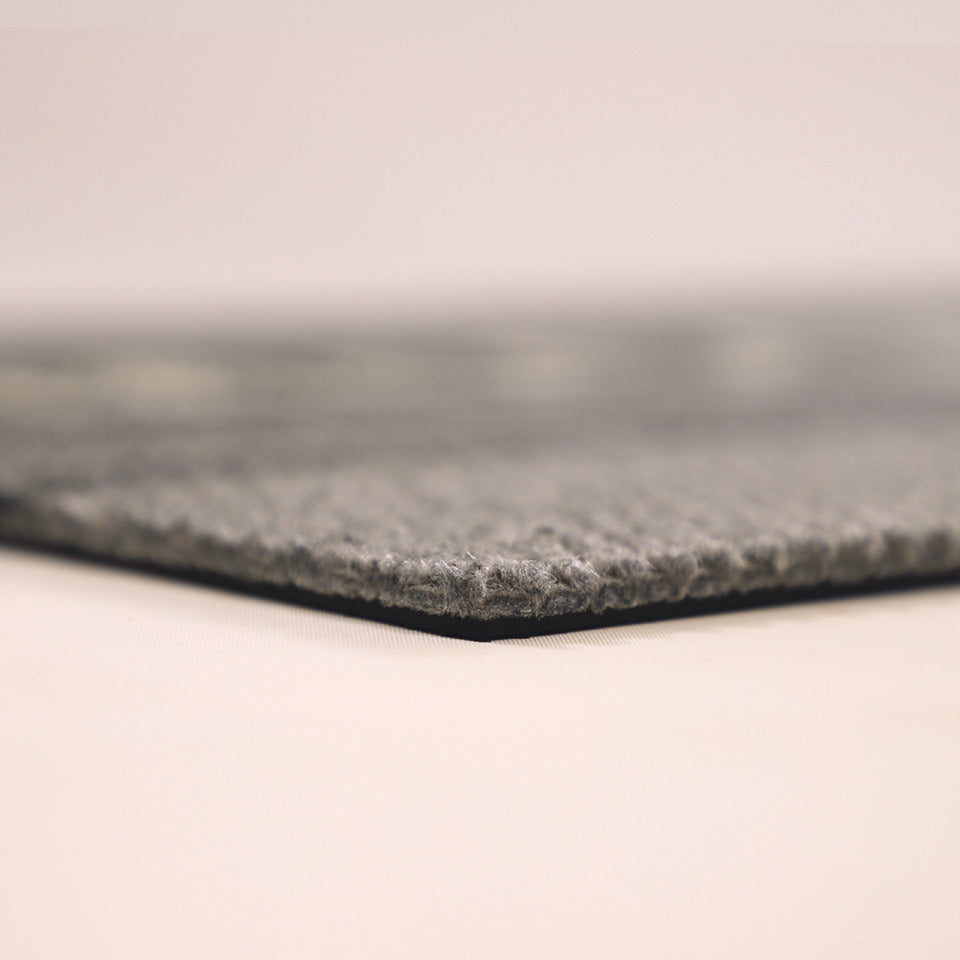 Close-up corner shot of Modern Moniker’s low profile and nonshedding grey surface.