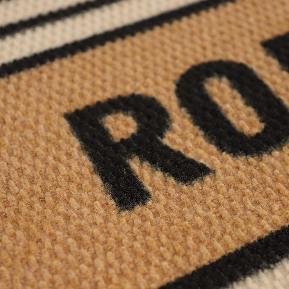 Detailed shot of Modern Moniker’s non shedding surface in black, white, and coir.
