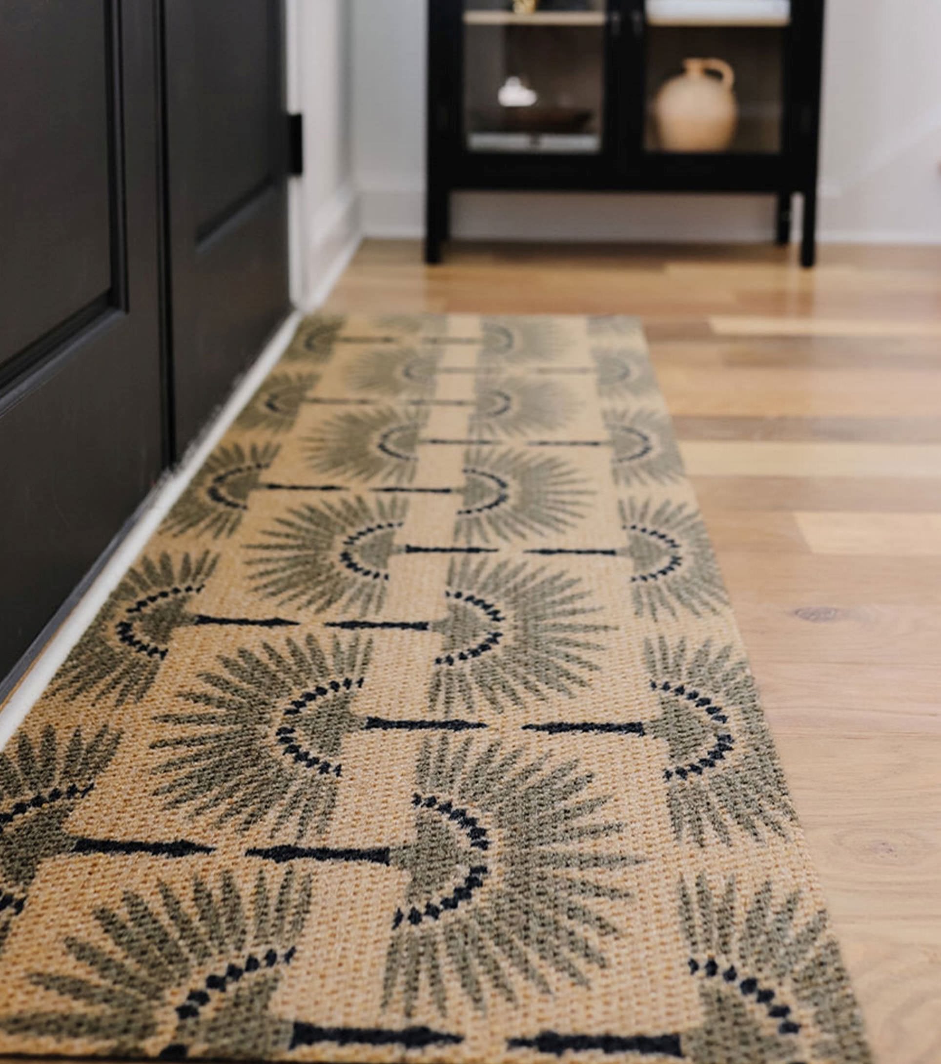Neighburly entrance mat with a non-shedding surface and low profile