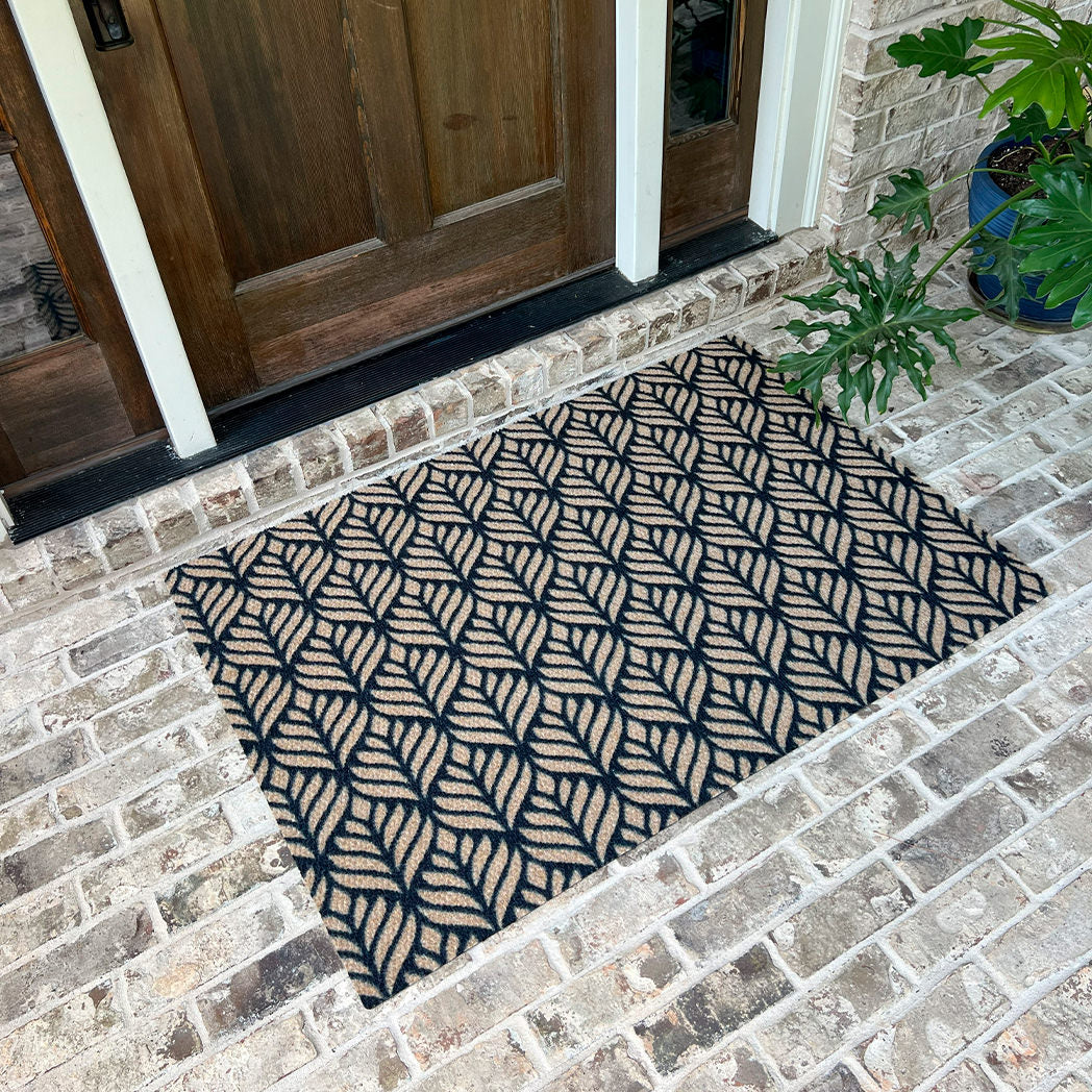 Large doormat for single door that extends slightly past the edges, with a repetitive floral design