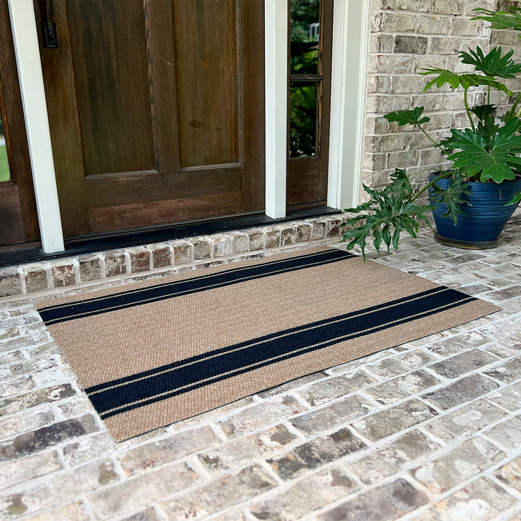 Large coir and black doormat that extends a little past the doors edged for maximum coverage
