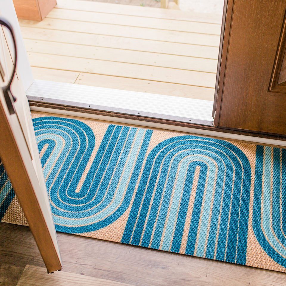 Neighburlys Retro Vibes double door doormat under a partially opened door.