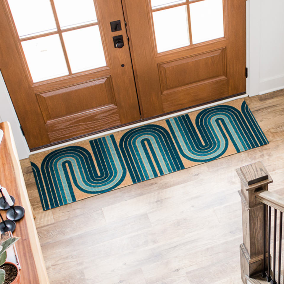 Neighbulry Retro Vibes inside doormat has a unique look and is placed just inside a set of large double doors.