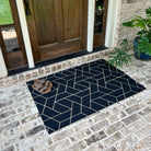 The geometrical Triangulation modern doormat in front of a door, which the mat extends slightly farther