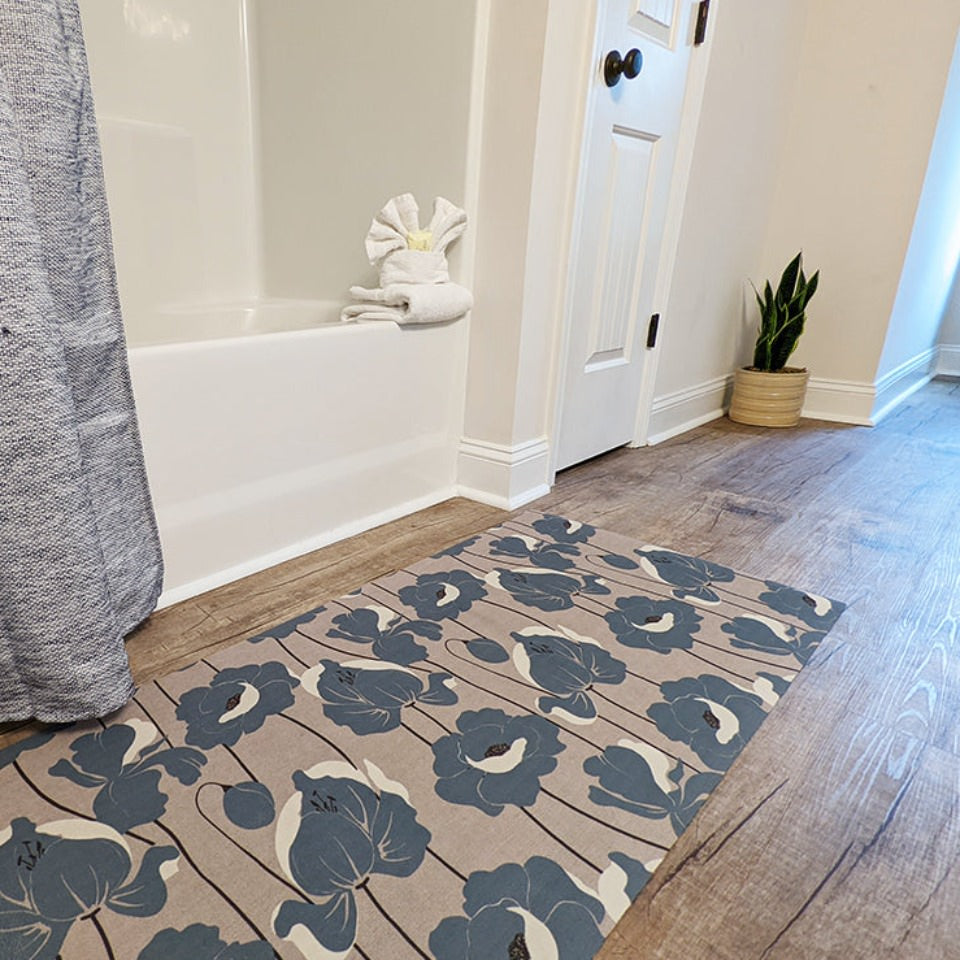 beautiful mat with neutral light beige (shiitake) base with poppy flowers all over in a storm cloud blue shade in a bathroom