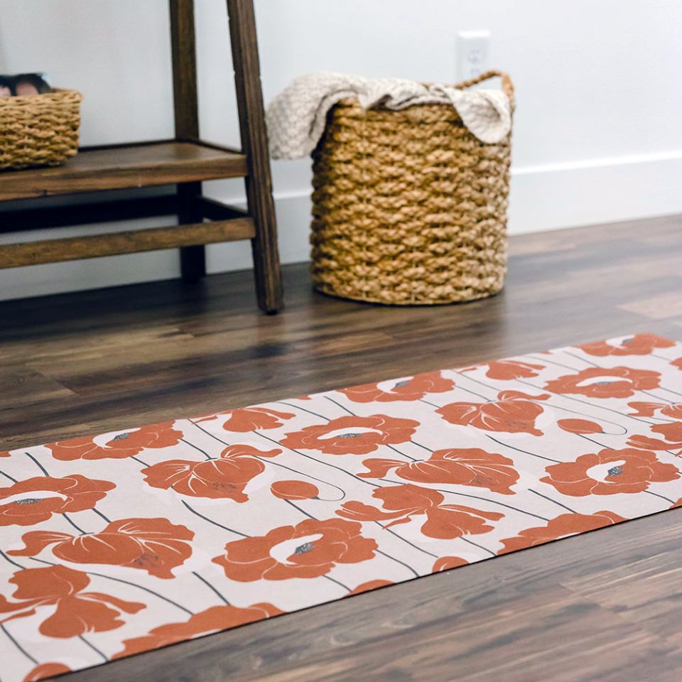 beautiful mat with neutral light beige (shiitake) base with poppy flowers all over in a deep orange (earthen jug) shade.