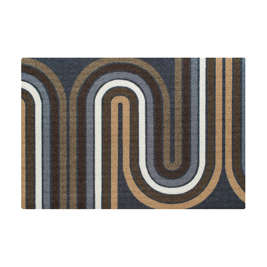 The groovy Retro Vibes Neighburly doormat with brown, blue, grey and white stripe making racetrack-like pattern on a dark grey/blue background