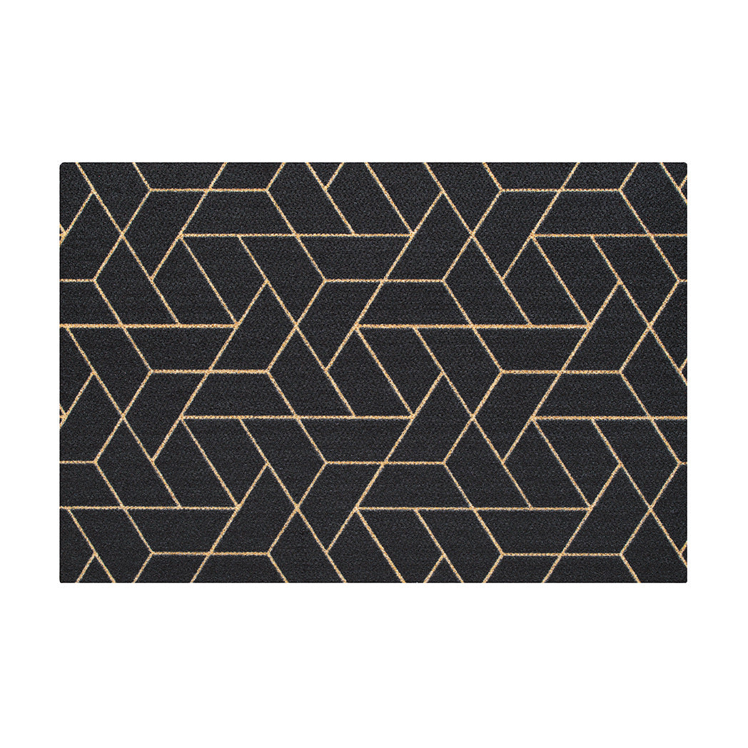 Top view of Neighburly's Triangulation large doormat made of geometrical triangle patterns, coir-colored, on a black mat
