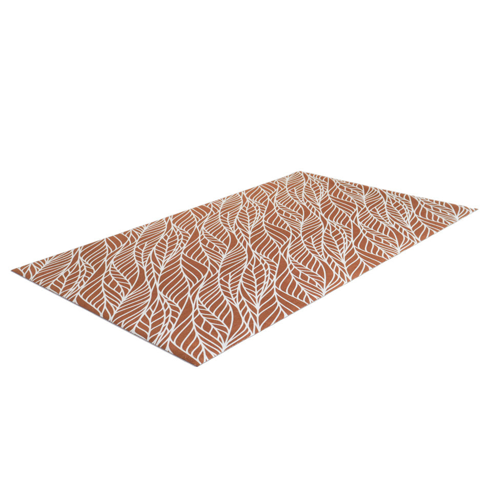 Overhead angle photo of Abstract cream colored leaf pattern on burnt orange linen look low profile washable floormat