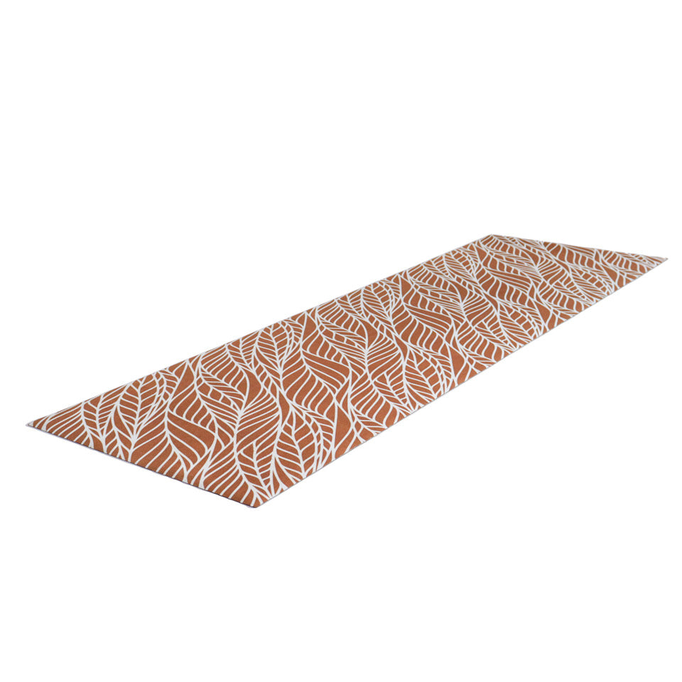 Overhead angle photo of Abstract cream colored leaf pattern on burnt orange linen look low profile washable floormat
