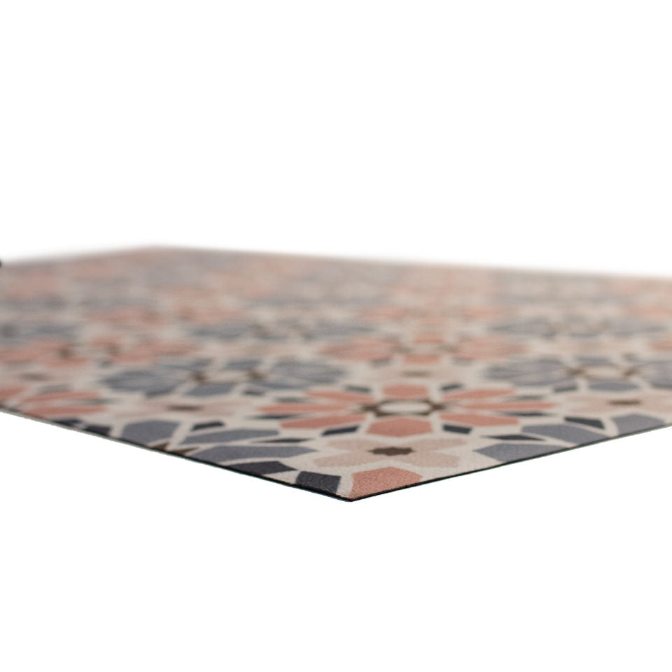 Low profile angle of Moroccan tiled washable indoor floor mat in pinks, blues, and beige