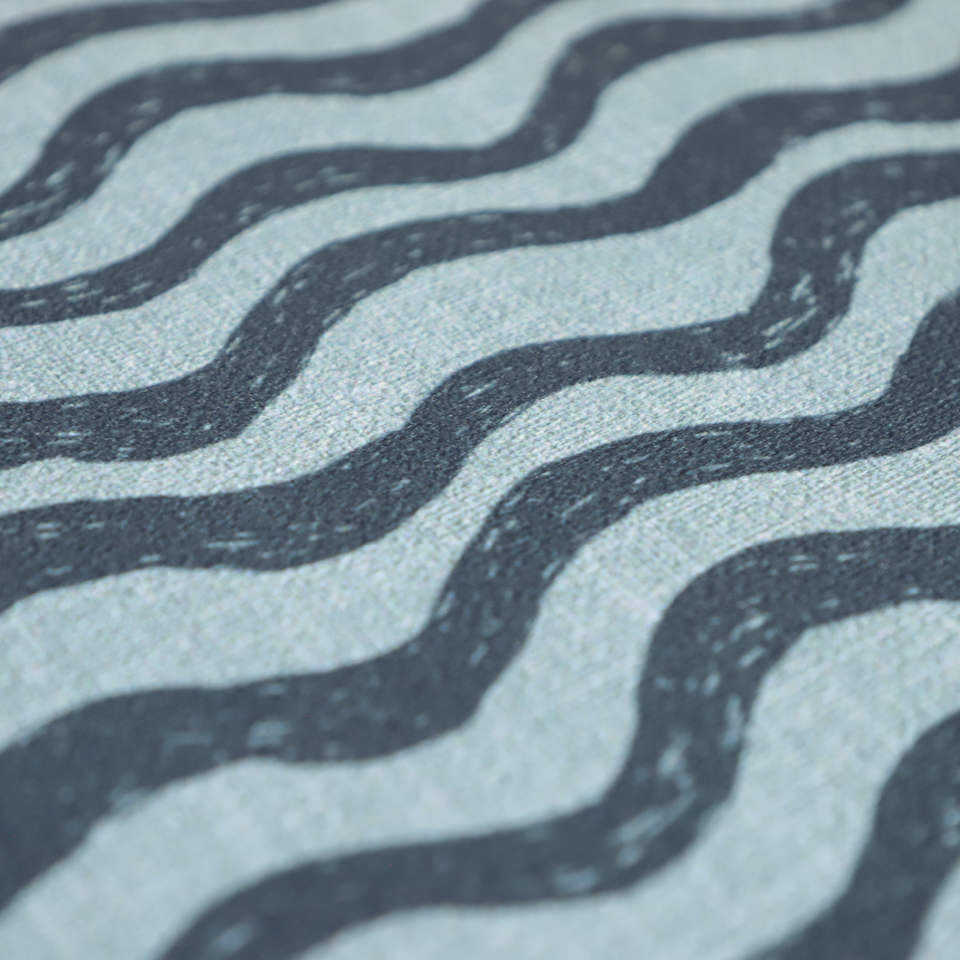 Close up of low profile surface in coastal blues in an organic waved pattern on a washable floor mat