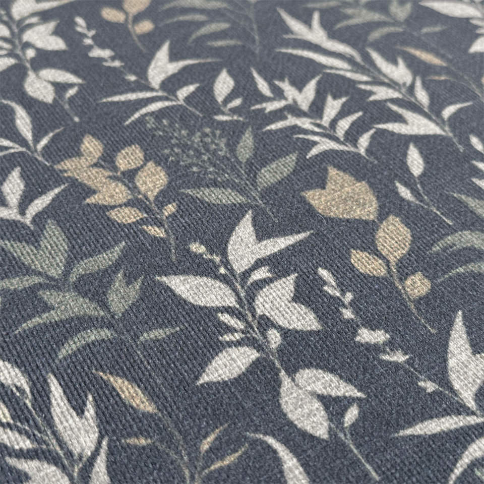 Close up of Ditsy Floral's soft felt surface printed with a sage and cream floral design on a navy background.