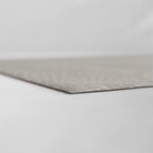 Super low profile corner shot of Shiitake tan colored linen background with white dotted fan design on a low profile washable floor mat